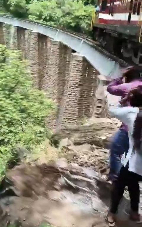 Sie machen Selfies auf der Brücke, als der Zug ankommt, und stürzen sich in einem schockierenden Video in die Schlucht